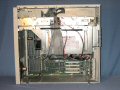 With the side panel removed it can be seen that the power supply is in the middle of the case with the drives above and expansion cards below. - quadra950-03.jpg