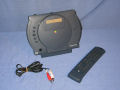 A PowerCD unit, remote control and the video/audio cable that is used when playing photo CDs. - powercd-01.jpg