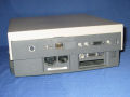 The rear of the Dock II features modem, audio, SCSI, serial, video and ADB ports.  Below them and to the right of the power supply are the two NuBus slots. - duo2300c-06.jpg