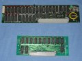 The two expansion cards removed from the system.  It can be fairly confidently dsaid that the lower card provides 64 kilobytes of ram (EXRAM64) and the conclusion could be made that the upper card contains 128 kilobytes and possibly also a real time clock (hence the battery). - ibm-jx-06.jpg